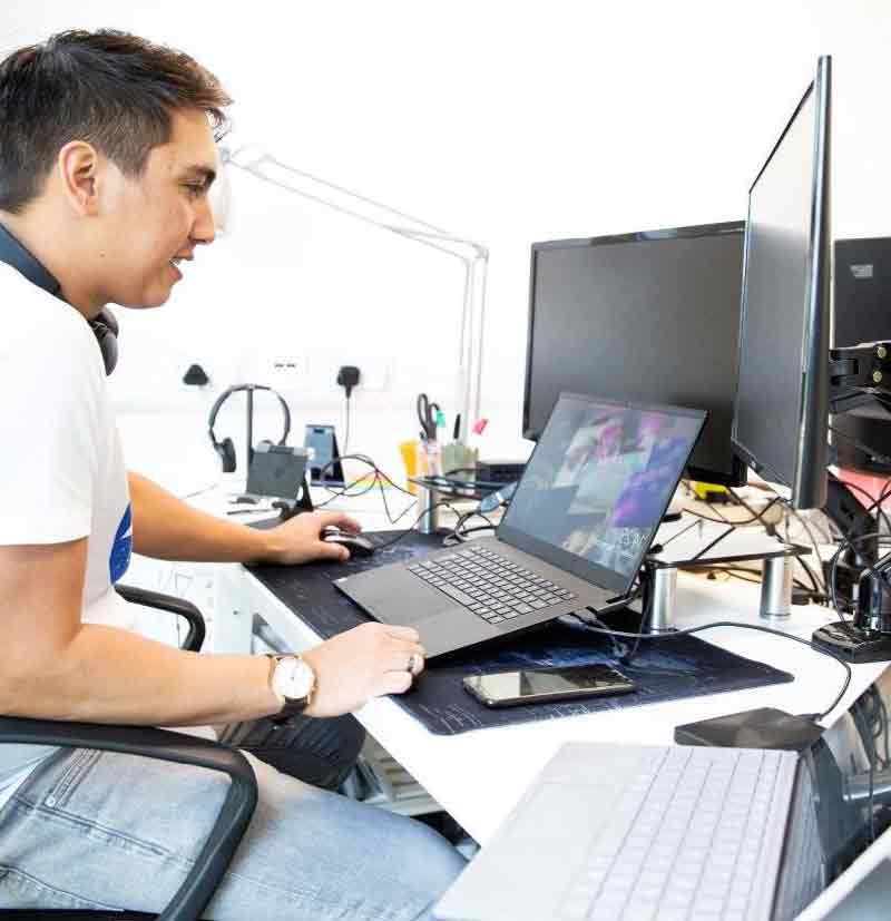 Man working on laptop in workspace