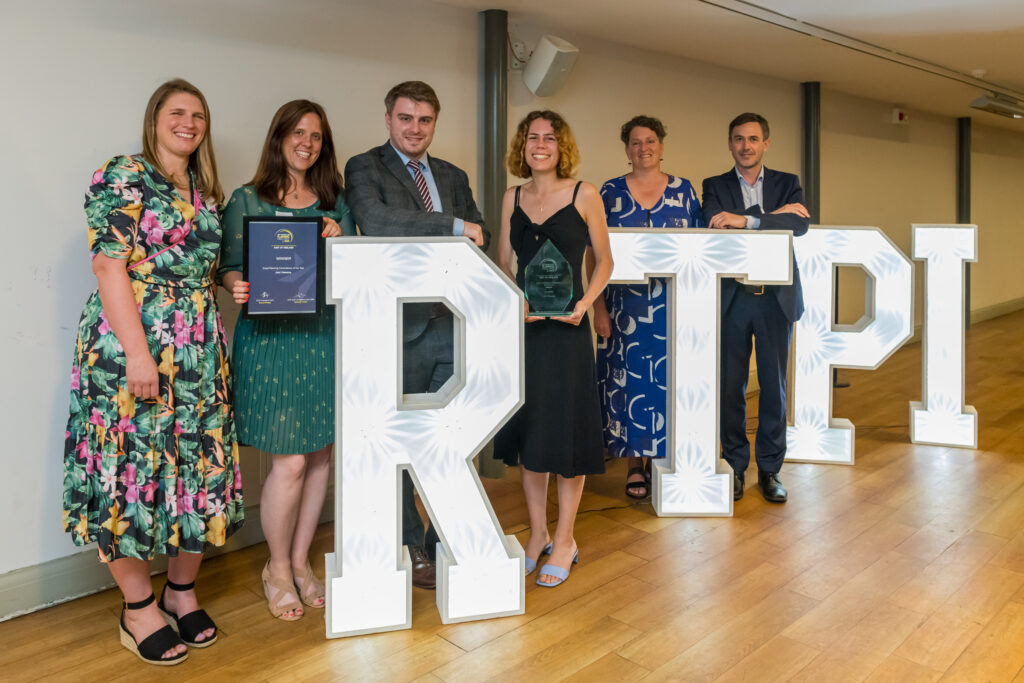 DAC Planning team standing with the RTPI logo at the awards ceremony, holding their award