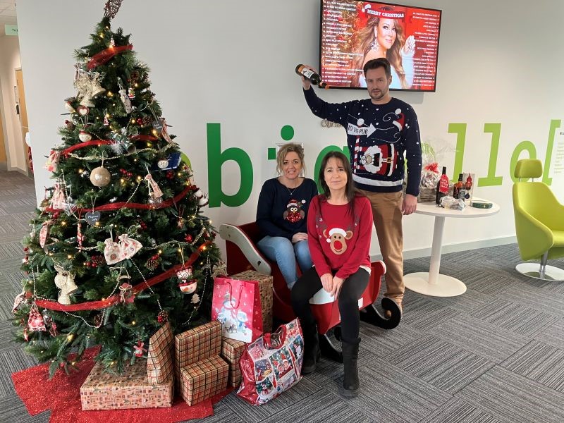 Georgina, Penny and Neil with a christmas tree in the ICKG lobby